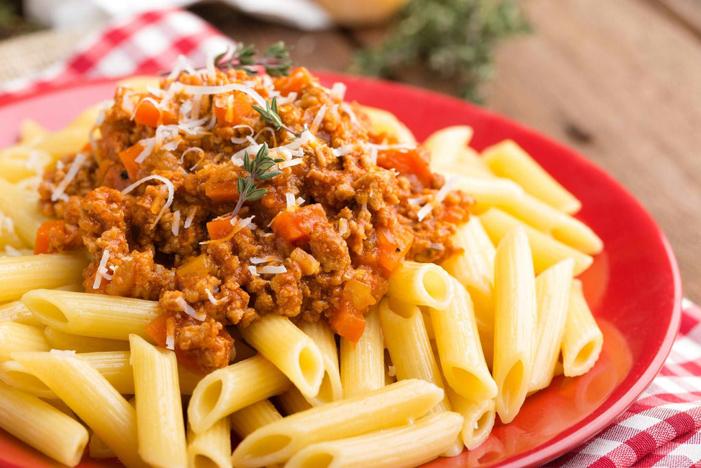 Pasta bolognese. Pasta served with a sauce of ground beef meat, tomato, onion, carrot and thyme. Traditional italian cuisine