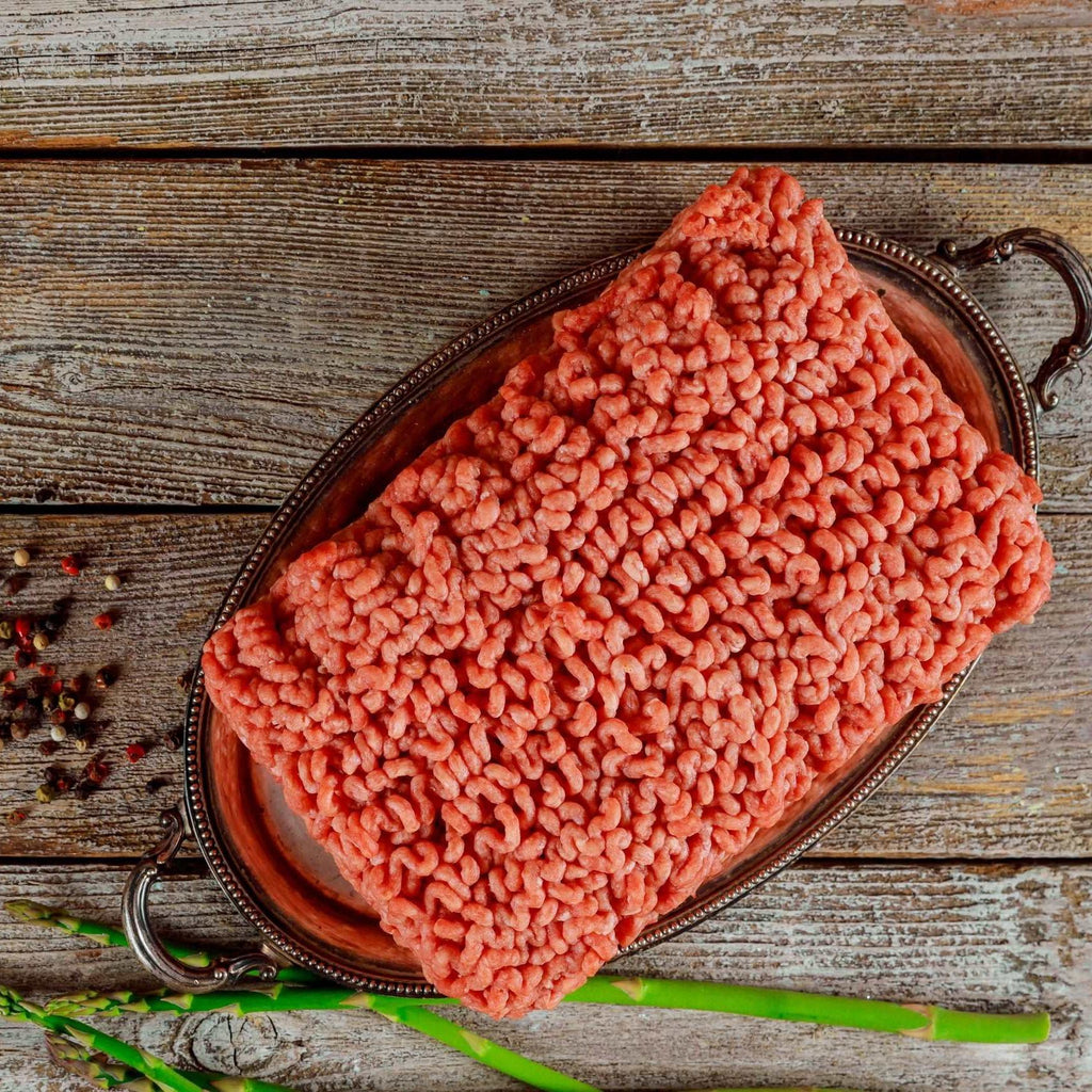 Flat lay fresh ingredients for cooking ground beef meat, black pepper and asparagus