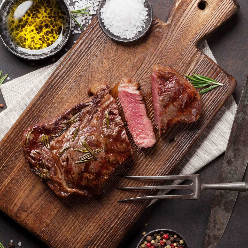 Grilled ribeye beef steak with red wine, herbs and spices