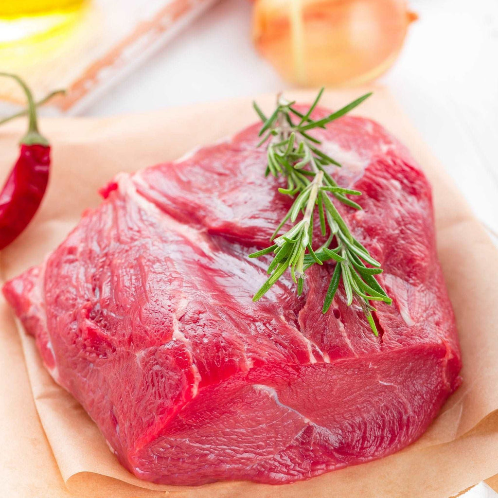 Raw beef meat tenderloin on white background with cooking ingredients closeup. Fresh beef meat on kitchen table