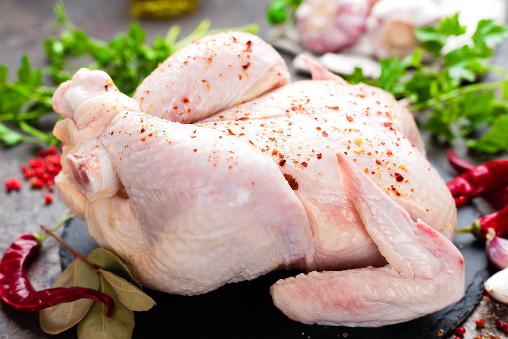 Raw chicken. Fresh whole chicken with ingredients for cooking